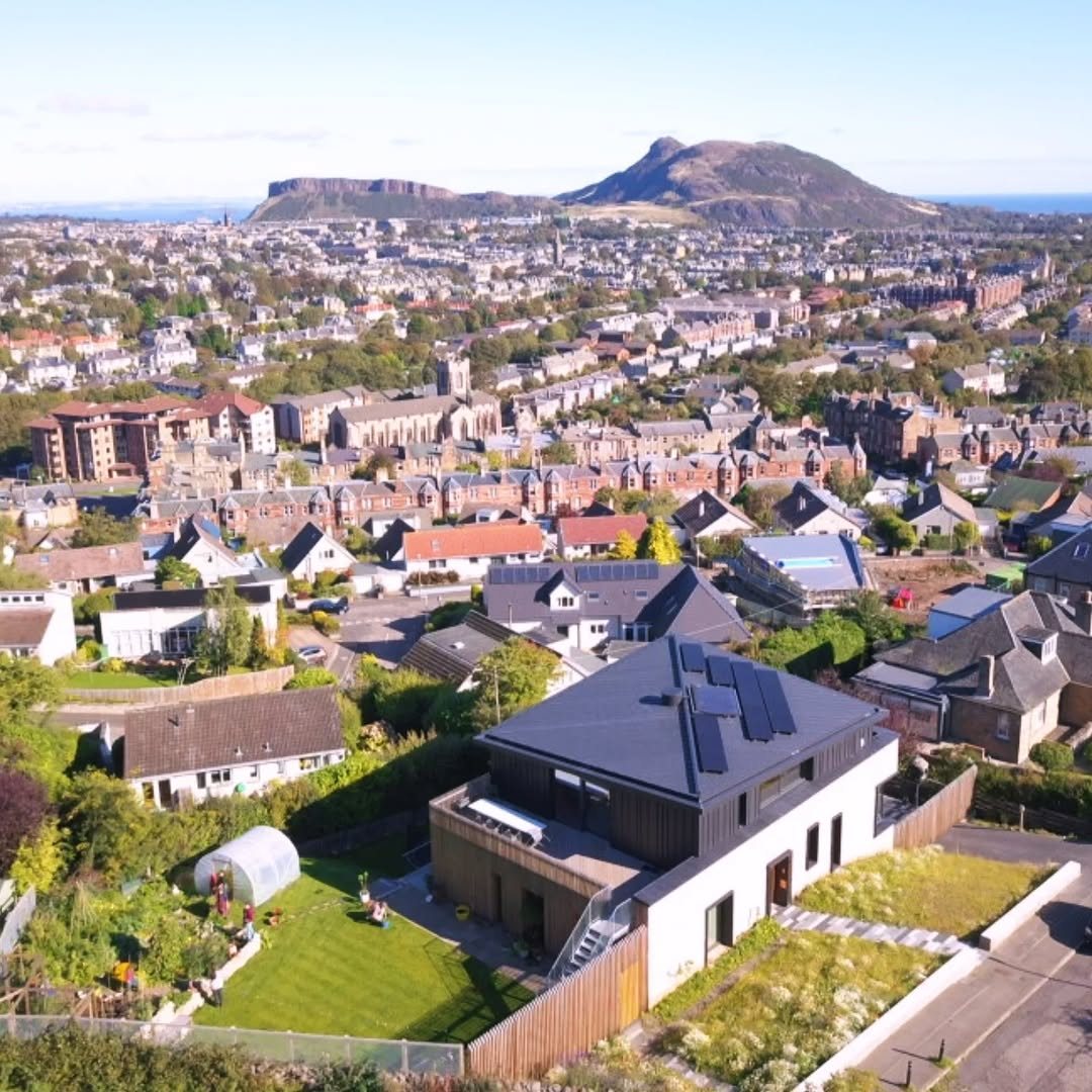 Modern dark-roofed house in Edinburgh with Arthur's Seat behind