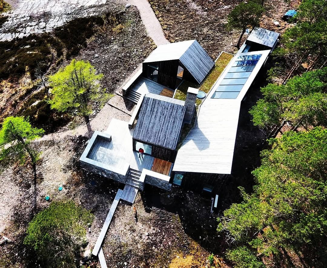 Contemporary timber house in woodland from above