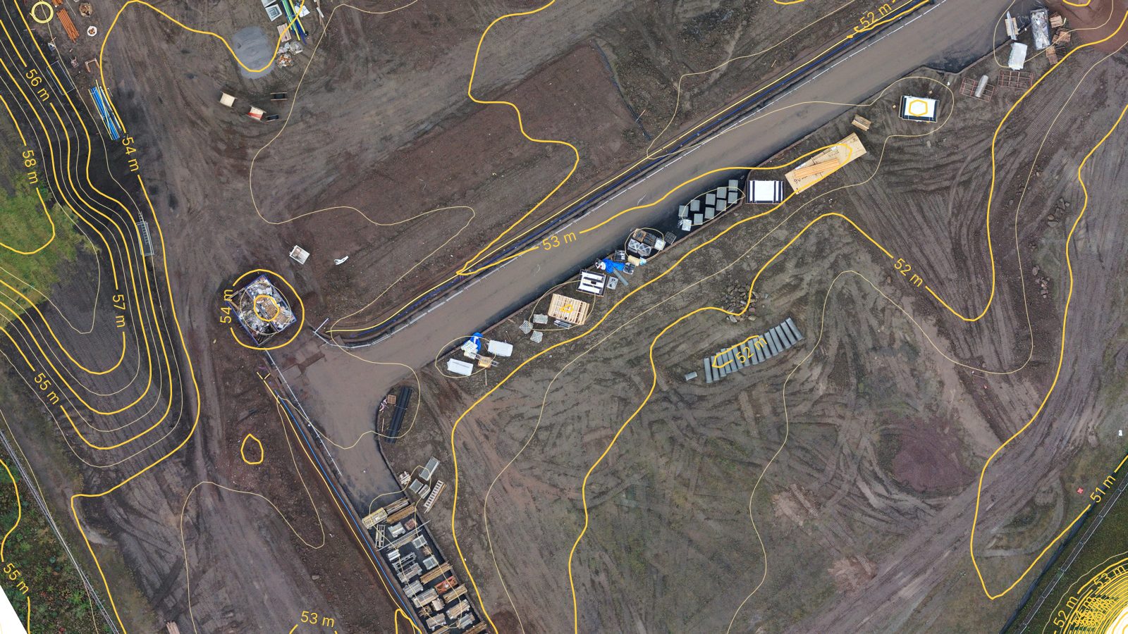 Straight-down aerial map of open development land with half-metre contour lines drawn over it